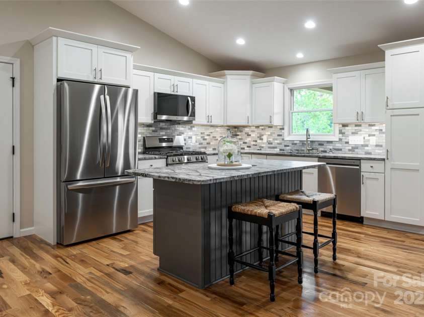 181 Flint Morgan Road, Mars Hill, NC 28754.  MLS# CAR4288459, YatesRealty ID 30594. The kitchen features stainless steel appliances and an island
