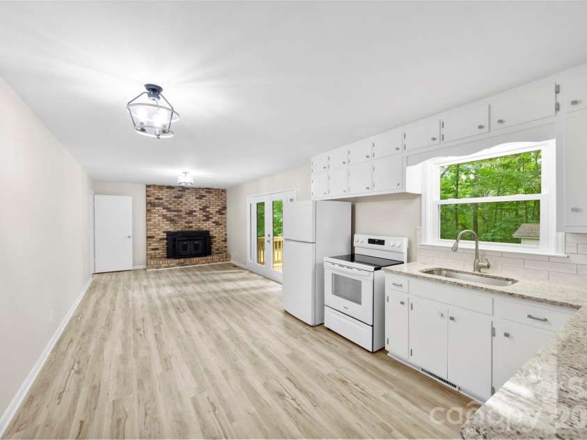 36183 Davis Drive, Albemarle, NC 28001.  MLS# CAR4391780, YatesRealty ID 30605. Kitchen and Den