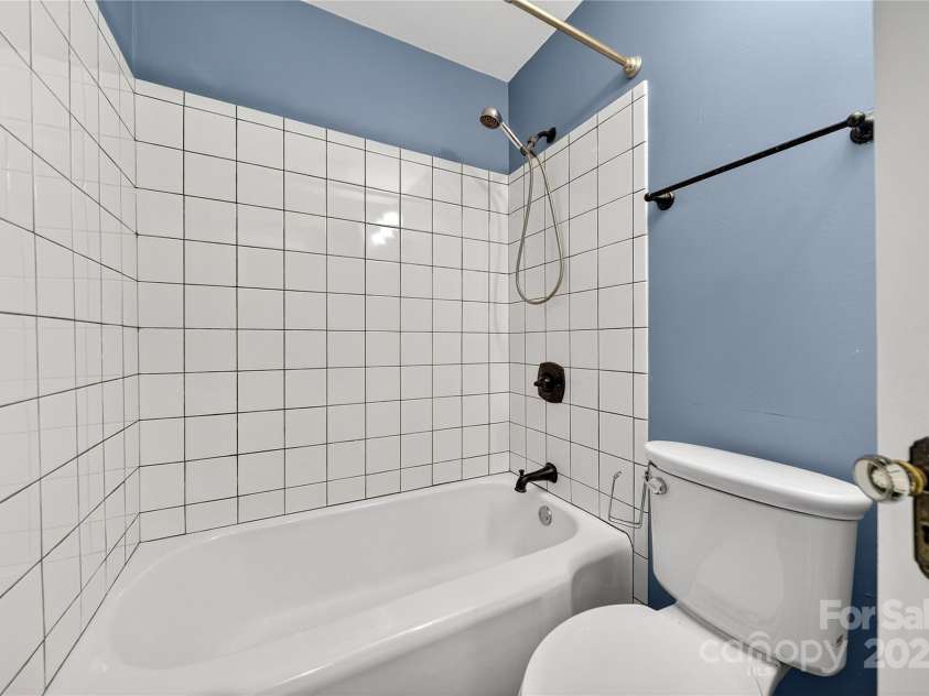 662 Carpenter Avenue, Mooresville, NC 28115.  MLS# CAR4286895, YatesRealty ID 30605. Full bathroom has original cast iron tub and simple 4x4