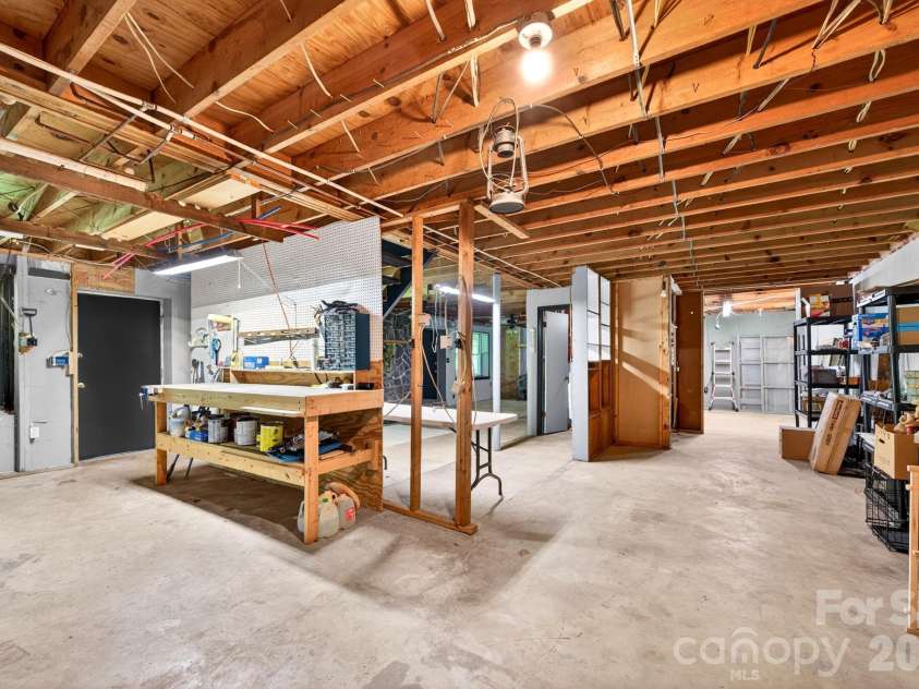 30 Reeves Drive, Burnsville, NC 28714.  MLS# CAR4391470, YatesRealty ID 30607. Basement Workbench Area