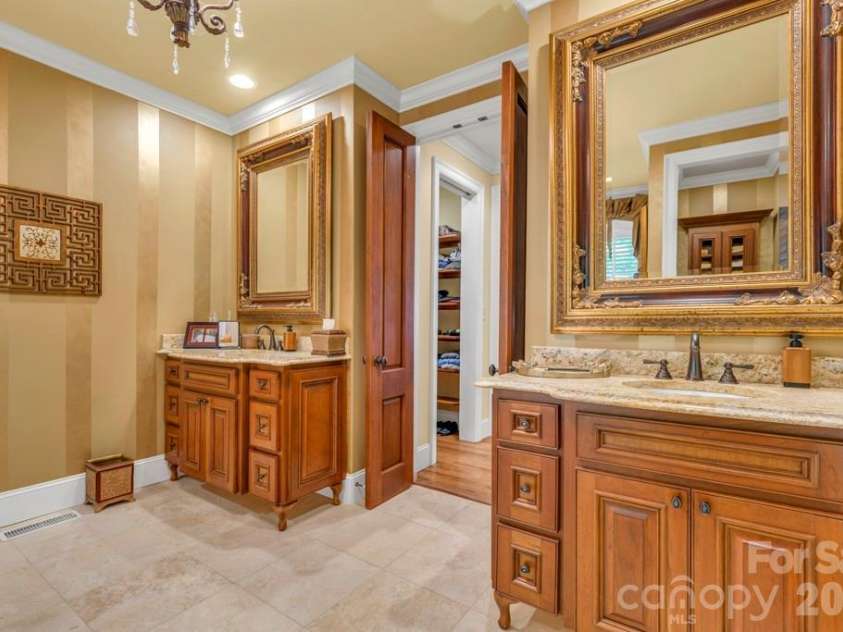 847 Old Orchard Road, Blowing Rock, NC 28605.  MLS# CAR4384622, YatesRealty ID 30618. Main-level primary suite bath with dual vanities & two walk-in closets