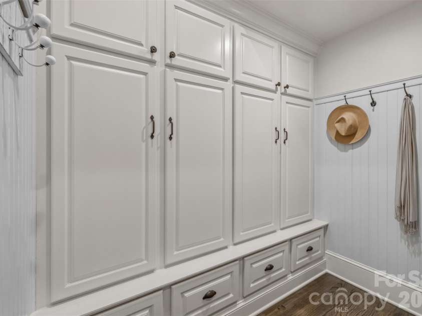 18407 Peninsula Cove Lane, Cornelius, NC 28031.  MLS# CAR4391272, YatesRealty ID 30620. A thoughtfully designed mudroom/drop zone features custom cabinetry, dedicated storage, and an organized transition space just off the garage.