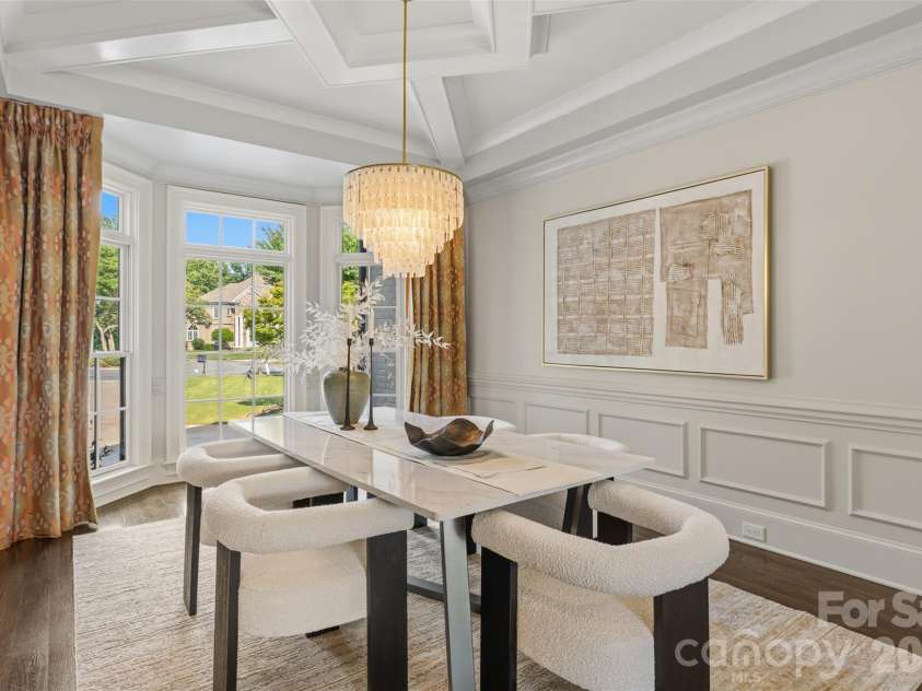 18407 Peninsula Cove Lane, Cornelius, NC 28031.  MLS# CAR4391272, YatesRealty ID 30620. Elegant dining room featuring coffered ceilings, custom millwork, and abundant natural light.