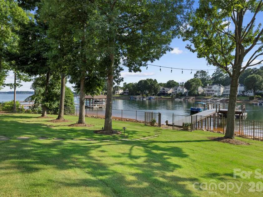 18407 Peninsula Cove Lane, Cornelius, NC 28031.  MLS# CAR4391272, YatesRealty ID 30620. Flat green space leading to dock.
