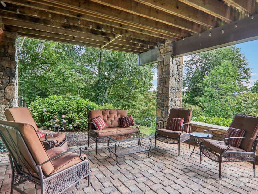 149 Cardinal Lane, Waynesville, NC 28786.  MLS# CAR4284459, YatesRealty ID 30625. Lower outside sitting area