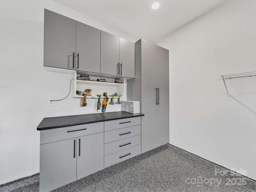 6063 Pier Drive, Denver, NC 28037.  MLS# CAR4286335, YatesRealty ID 30660. Garage with built in workbench/cabinets and epoxy floors