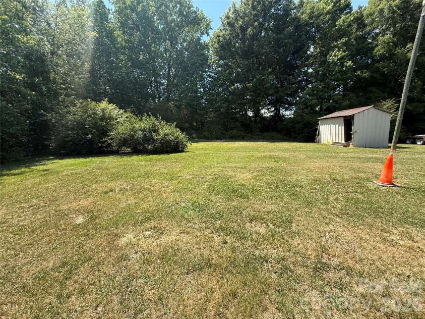 129 Sunset Drive, Troy, NC 27371.  MLS# CAR4384122, YatesRealty ID 30670. Back yard and storage building 