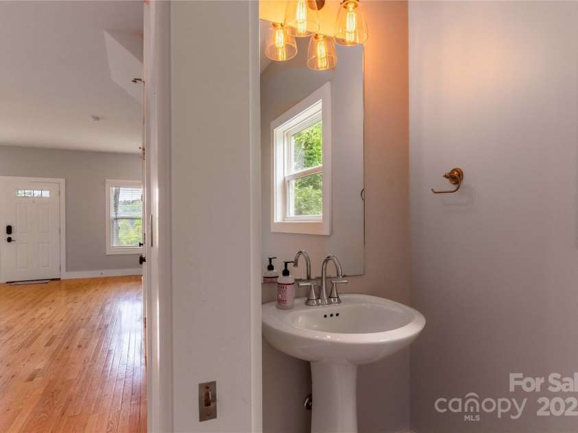 5 Koenig Way, Asheville, NC 28804.  MLS# CAR4280267, YatesRealty ID 3068. 1/2 bath with pocket door.