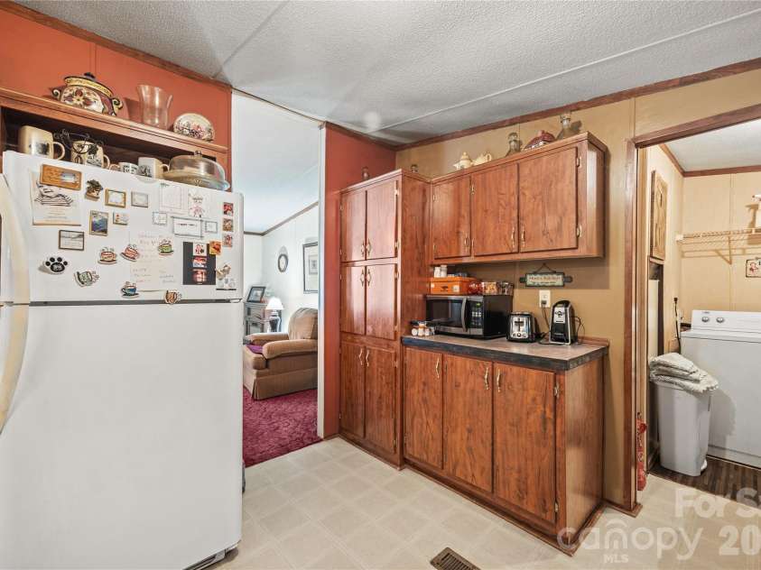323 Carlyle Road, Troutman, NC 28166.  MLS# CAR4381311, YatesRealty ID 30683. Kitchen opens to the laundry and living room area.