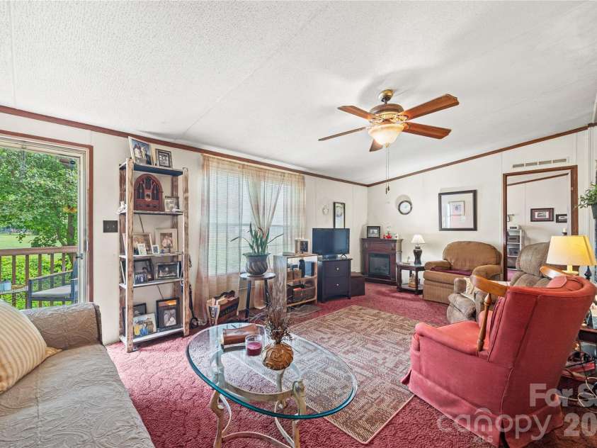 323 Carlyle Road, Troutman, NC 28166.  MLS# CAR4381311, YatesRealty ID 30683. Living room has an electric fireplace that can stay.