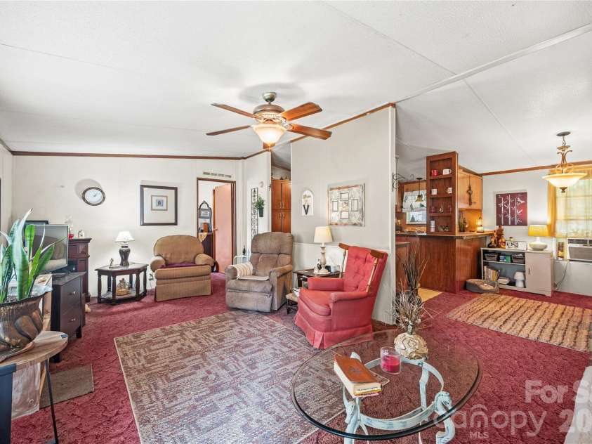 323 Carlyle Road, Troutman, NC 28166.  MLS# CAR4381311, YatesRealty ID 30683. The living room opens up to the kitchen.