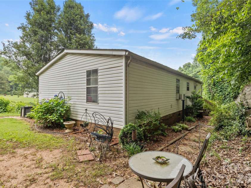 323 Carlyle Road, Troutman, NC 28166.  MLS# CAR4381311, YatesRealty ID 30683. Walkway to the back door from driveway.