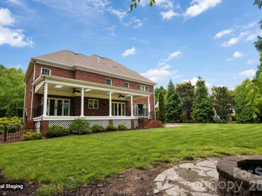 880 Hickory Stick Drive, Fort Mill, SC 29715.  MLS# CAR4379413, YatesRealty ID 30693. Large level backyard with stone firepit
