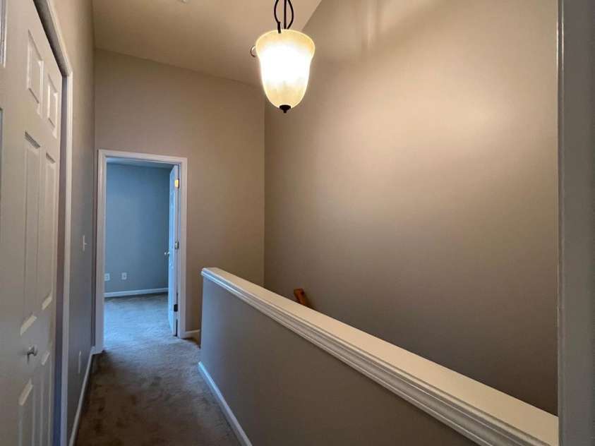 155 Limerick Road, Mooresville, NC 28115.  MLS# CAR4284761, YatesRealty ID 30708. At the top of the stairs, you will discover this nice hanging light, and the doorway to the front bedroom suite.