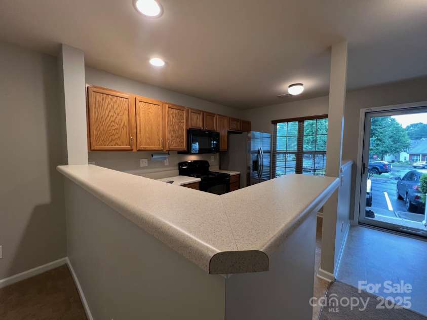155 Limerick Road, Mooresville, NC 28115.  MLS# CAR4284761, YatesRealty ID 30708. The front door has a nice full glass storm door that lets the natural light inside. Upon entering the townhome, you will immediately notice that this unit is move-in ready. Most of the appliances are new. The home has 