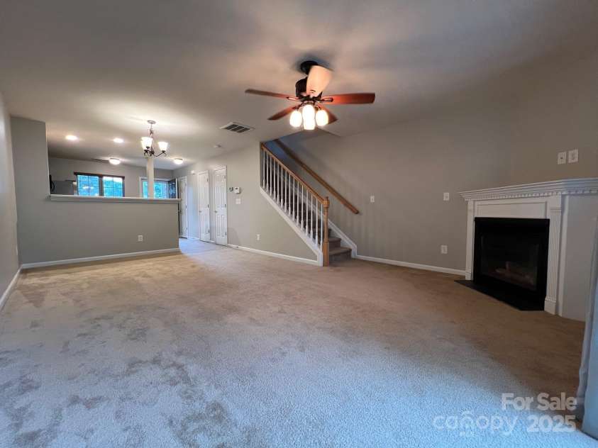 155 Limerick Road, Mooresville, NC 28115.  MLS# CAR4284761, YatesRealty ID 30708. The kitchen is open to the family room which has a ceiling fan.