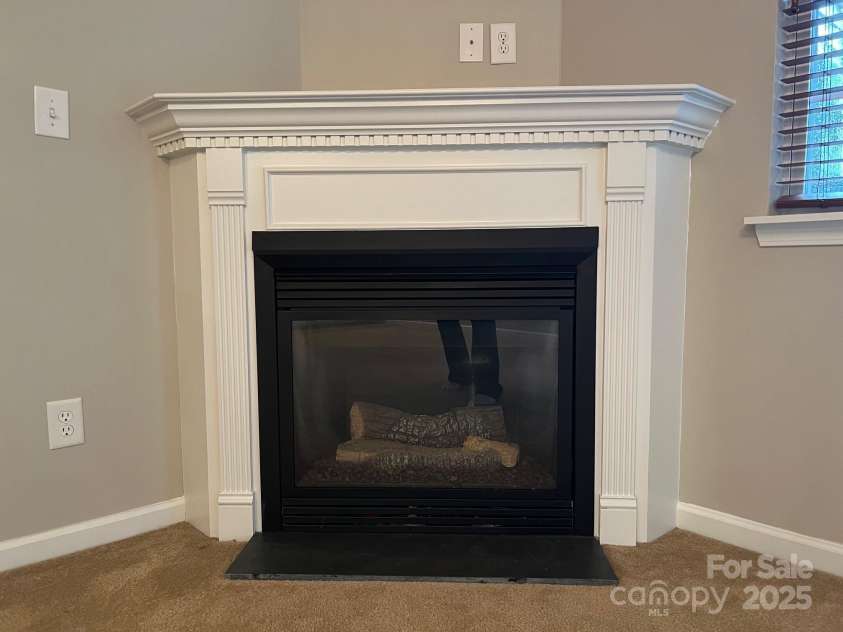 155 Limerick Road, Mooresville, NC 28115.  MLS# CAR4284761, YatesRealty ID 30708. There is a cozy fireplace with gas logs which is the focus of the family room.