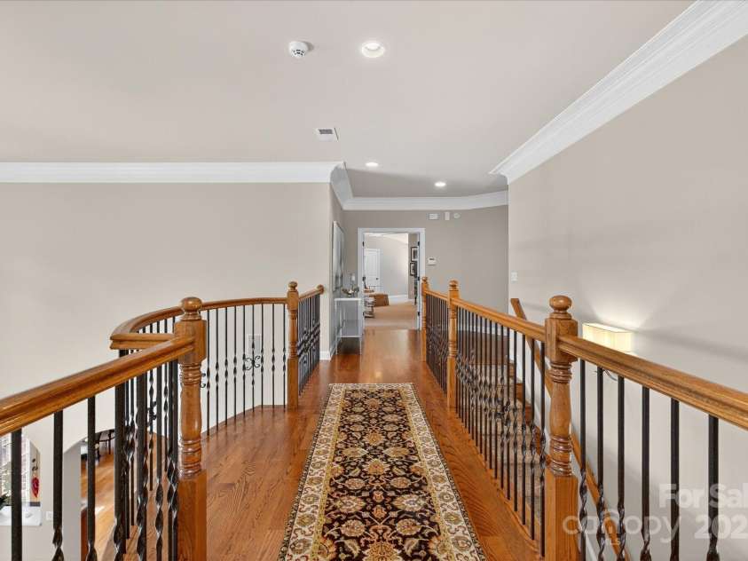 1100 Seminole Drive, Indian Land, SC 29707.  MLS# CAR4285132, YatesRealty ID 30711. Catwalk with oak flooring and wrought iron spindles