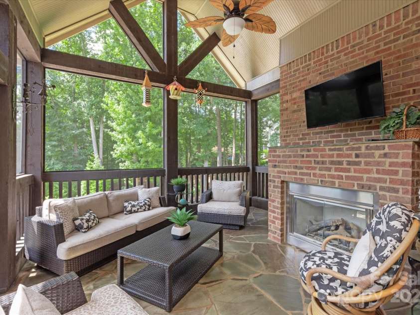 1100 Seminole Drive, Indian Land, SC 29707.  MLS# CAR4285132, YatesRealty ID 30711. Screen porch with gas fireplace and vaulted ceilings leads to the terrace