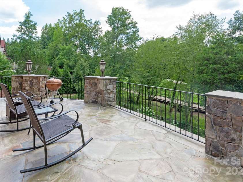 1100 Seminole Drive, Indian Land, SC 29707.  MLS# CAR4285132, YatesRealty ID 30711. Stone terrace with built-in lighting overlooks the 13th fairway