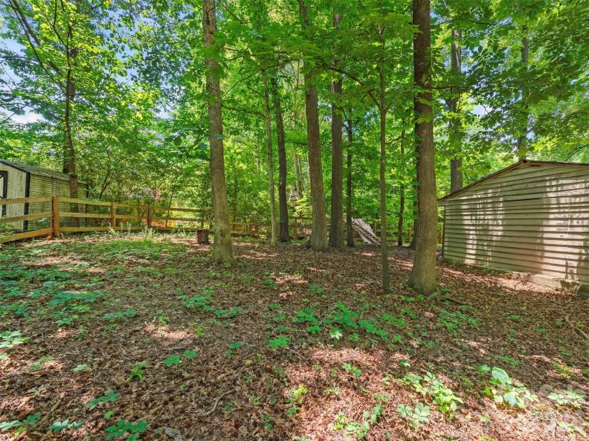 3814 Wonderland Drive, Matthews, NC 28104.  MLS# CAR4391845, YatesRealty ID 30724. Wooded backyard
