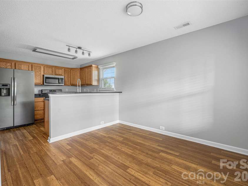 9535 Forest Path Drive, Charlotte, NC 28269.  MLS# CAR4388115, YatesRealty ID 30726. Dining area looking into kitchen