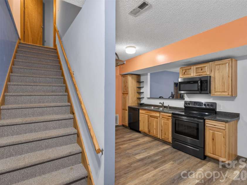 66 Misery Ridge None, Mill Spring, NC 28756.  MLS# CAR4386144, YatesRealty ID 30739. Stairs from basement apt to upper level.