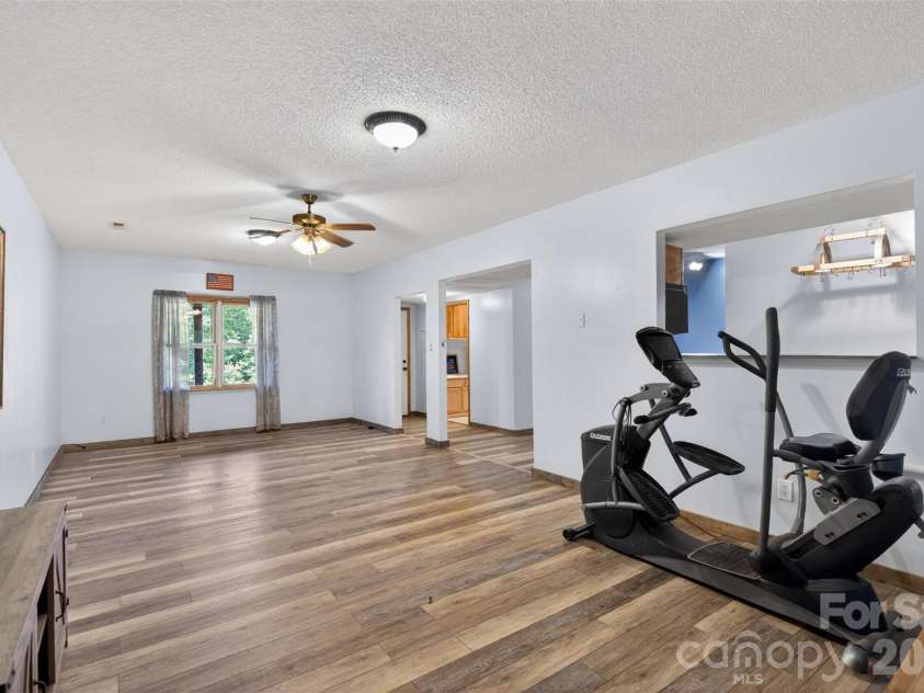 66 Misery Ridge None, Mill Spring, NC 28756.  MLS# CAR4386144, YatesRealty ID 30739. View of great room and pass through to kitchen.