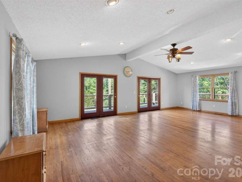 66 Misery Ridge None, Mill Spring, NC 28756.  MLS# CAR4386144, YatesRealty ID 30739. View of Great Room.  Double doors open to wrap deck
