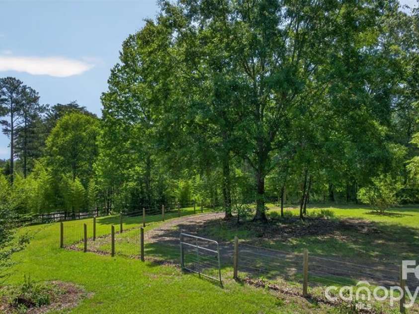 66 Misery Ridge Trail, Mill Spring, NC 28756.  MLS# CAR4385906, YatesRealty ID 30739. Beautiful trees spot the property for shade.