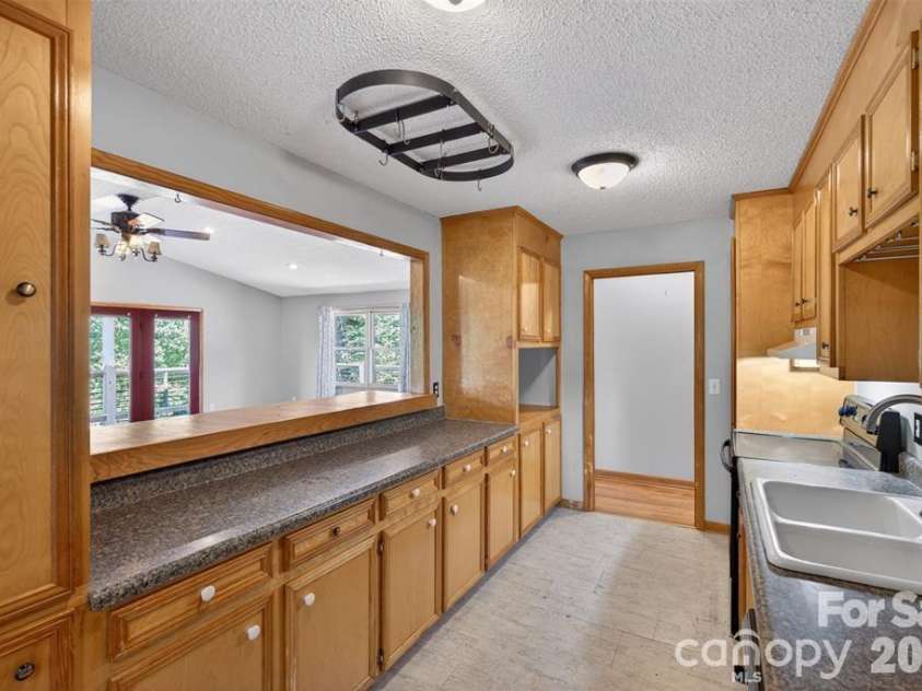 66 Misery Ridge Trail, Mill Spring, NC 28756.  MLS# CAR4385906, YatesRealty ID 30739. Galley kitchen for easy access of ample cabinetry.