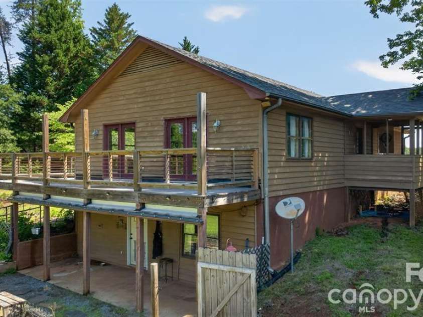 66 Misery Ridge Trail, Mill Spring, NC 28756.  MLS# CAR4385906, YatesRealty ID 30739. Side view shows entry to downstairs apartment.