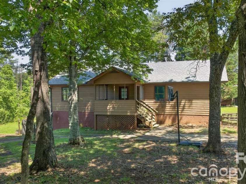 66 Misery Ridge Trail, Mill Spring, NC 28756.  MLS# CAR4385906, YatesRealty ID 30739. This charming ranch-style home features a spacious apartment in the full basement, perfect for guests or rental income.  Enjoy the benefits of single-level living while having additional space for family or potenti