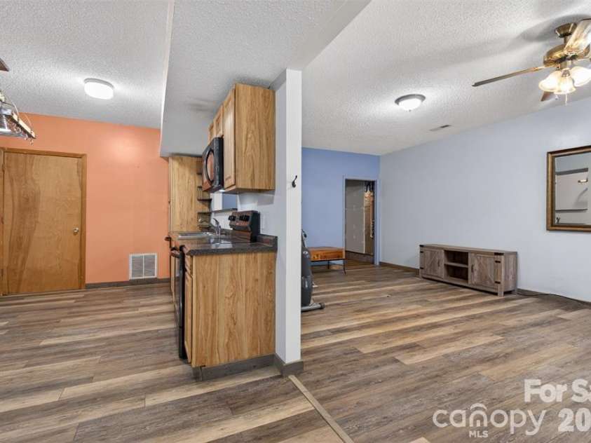 66 Misery Ridge Trail, Mill Spring, NC 28756.  MLS# CAR4385906, YatesRealty ID 30739. To the right is the great room.