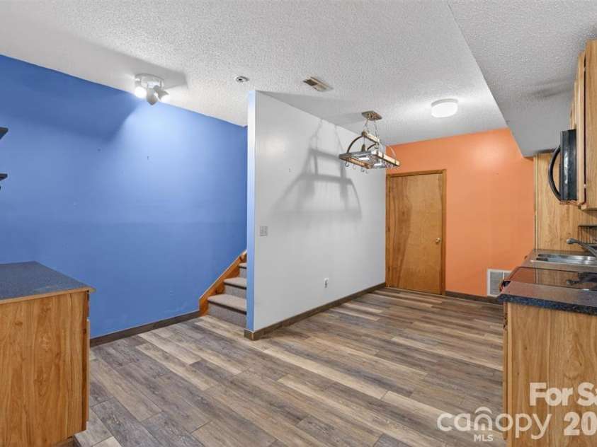 66 Misery Ridge Trail, Mill Spring, NC 28756.  MLS# CAR4385906, YatesRealty ID 30739. View 2 of kitchen. Door showing is access to one of the bonus rooms.