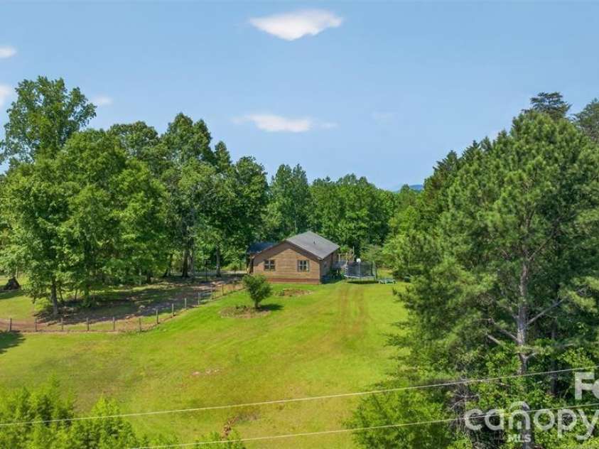 66 Misery Ridge Trail, Mill Spring, NC 28756.  MLS# CAR4385906, YatesRealty ID 30739. View of right side yard that borders Robertson Rd.  For added convenience, can add drive from paced road.