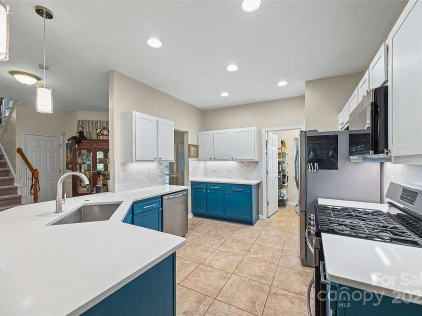 7029 Scuppernong Court, Charlotte, NC 28215.  MLS# CAR4277140, YatesRealty ID 30747. Updated Kitchen featureing painted cabinets, white quartz, SS appliances and a tile backsplash