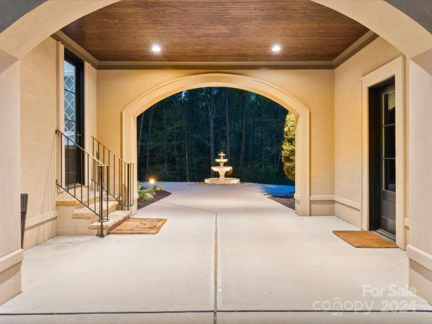 9044 Island Point Road, Charlotte, NC 28278.  MLS# CAR4135509, YatesRealty ID 3075. Step through the elegantly covered entryway that leads to a spacious garage area, accommodating up to eight car garage, complete with ample parking