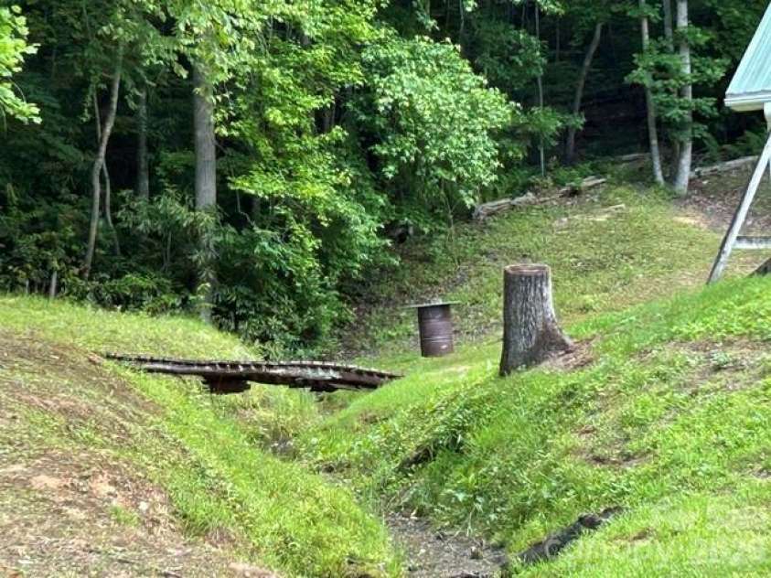 726 Israel Road, Brevard, NC 28712.  MLS# CAR4392517, YatesRealty ID 30772. Backyard stream