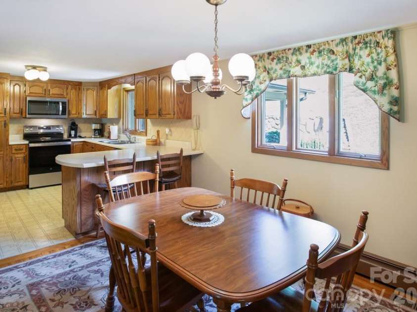 293 Dillardtown Road, Sylva, NC 28779.  MLS# CAR4392955, YatesRealty ID 30775. Dining area into kitchen