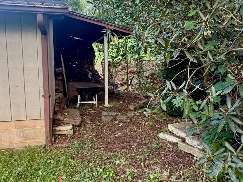 293 Dillardtown Road, Sylva, NC 28779.  MLS# CAR4392955, YatesRealty ID 30775. Wood storage space behind outbuilding