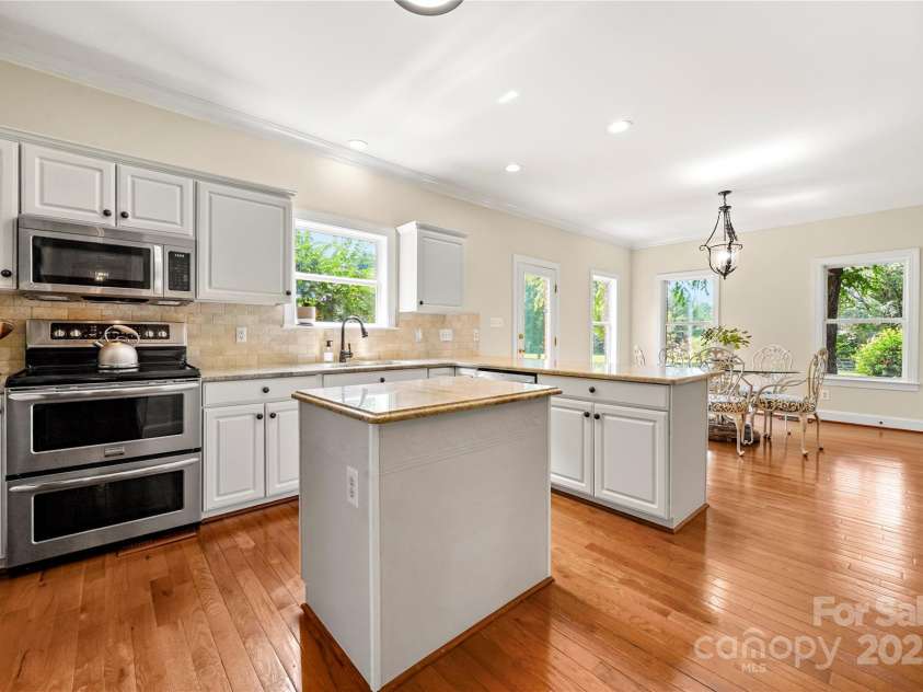 8173 Shannon Woods Lane, Weddington, NC 28104.  MLS# CAR4274910, YatesRealty ID 30803. Kitchen features double ovens granite counter tops,coffee bar