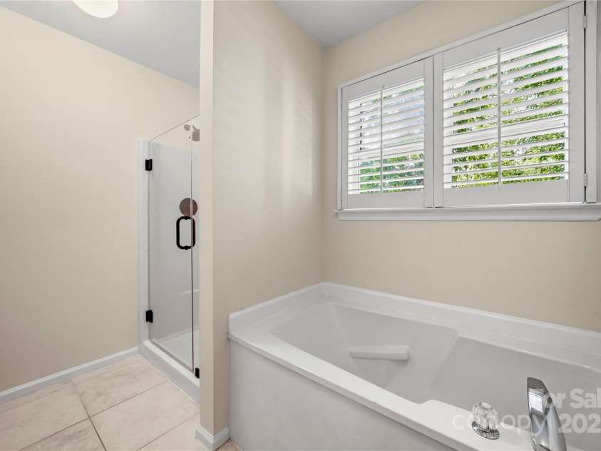 8173 Shannon Woods Lane, Weddington, NC 28104.  MLS# CAR4274910, YatesRealty ID 30803. Upstairs bathroom with new shower door and faucets