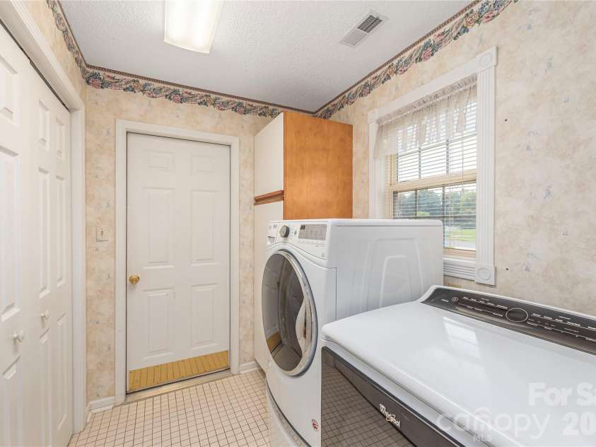 11 Heather Way, Candler, NC 28715.  MLS# CAR4381807, YatesRealty ID 30816. Laundry area