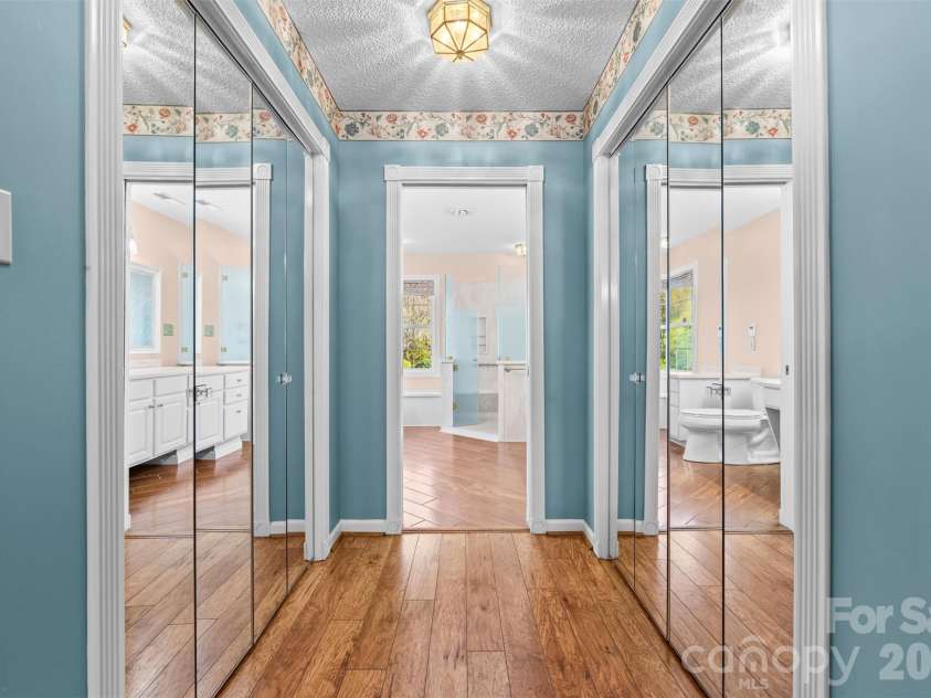 11 Heather Way, Candler, NC 28715.  MLS# CAR4435502, YatesRealty ID 30816. Hallway with closets in Primary Bedroom