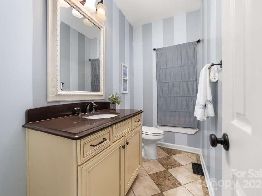 12214 Provincetowne Drive, Charlotte, NC 28277.  MLS# CAR4282352, YatesRealty ID 30824. Half bathroom on main level with custom tile floor