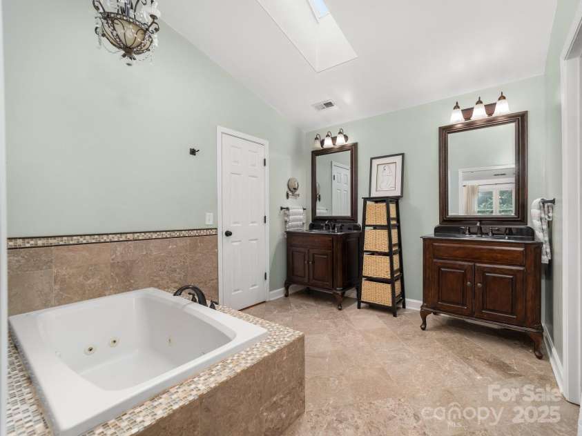 12214 Provincetowne Drive, Charlotte, NC 28277.  MLS# CAR4282352, YatesRealty ID 30824. Primary bathroom with dual vanities and walk-in closet