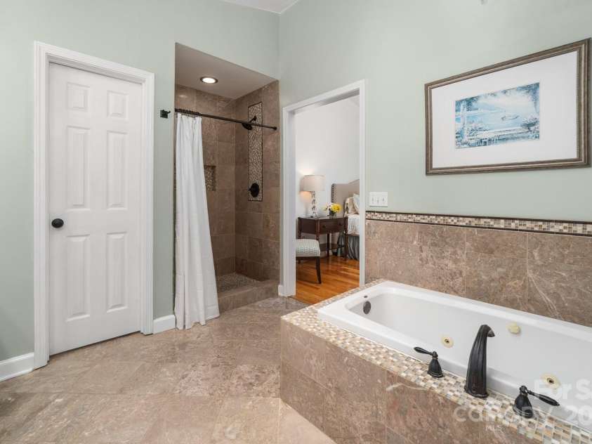 12214 Provincetowne Drive, Charlotte, NC 28277.  MLS# CAR4282352, YatesRealty ID 30824. Primary bathroom with jetted tub and separate tiled shower