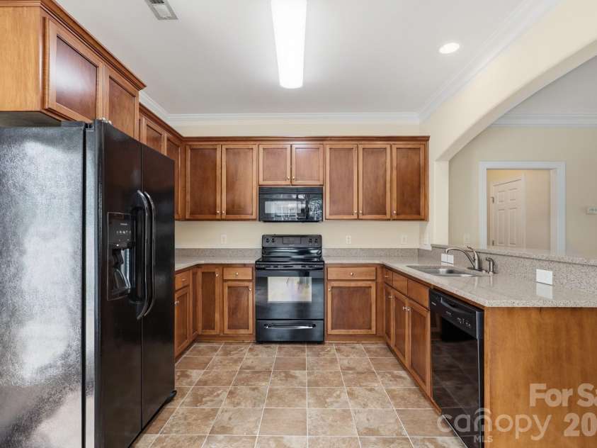 5945 Village Drive, Concord, NC 28027.  MLS# CAR4391952, YatesRealty ID 30834. Kitchen offers lots of counter space and cabinets 