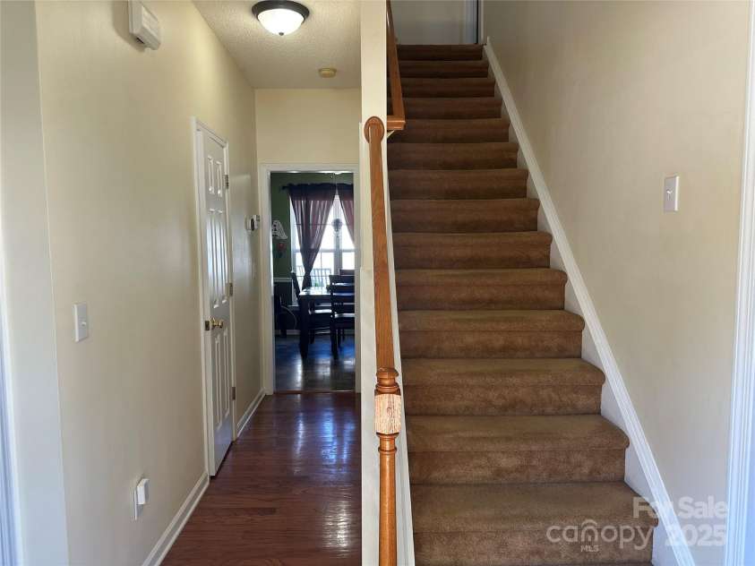 5845 Mahogany Place, Concord, NC 28025.  MLS# CAR4283667, YatesRealty ID 30850. A wood floor entry as you enter the home with stairs at the front door leading you to the bedrooms and bonus room on the upper floor.